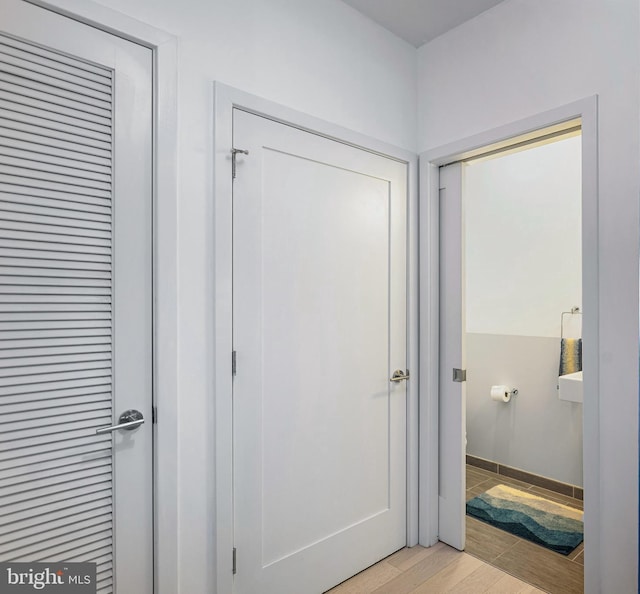 interior space featuring light wood-type flooring and baseboards