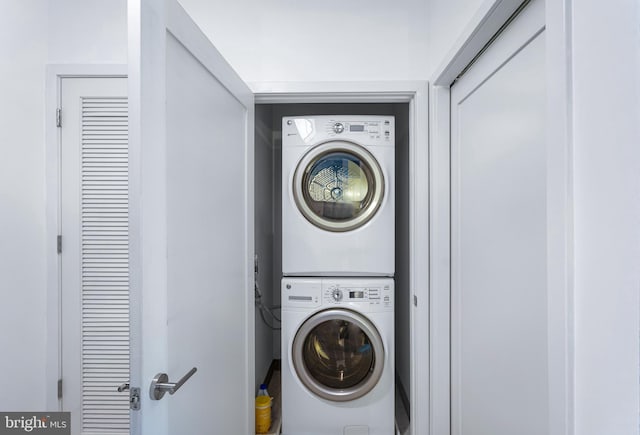 laundry room featuring laundry area and stacked washer and clothes dryer