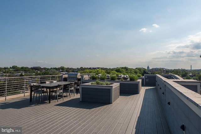 deck featuring grilling area and outdoor dining space