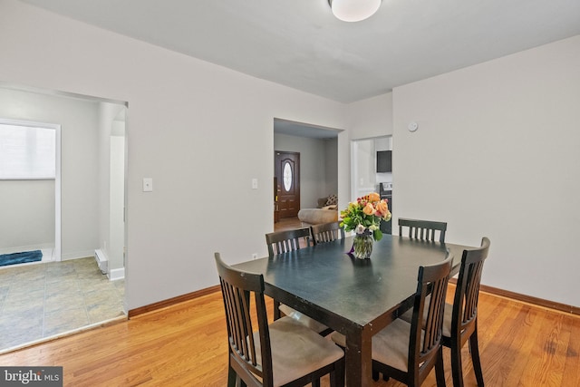 dining room with light wood-style floors and baseboards