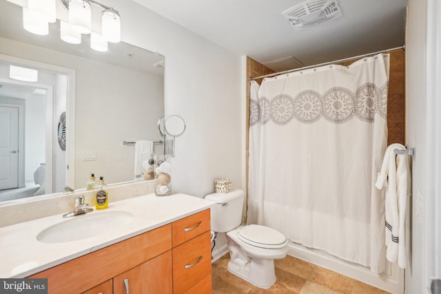 bathroom with toilet, visible vents, and vanity