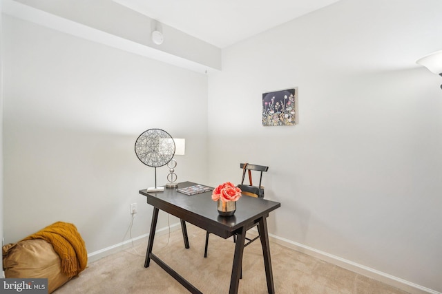 office featuring baseboards and light colored carpet