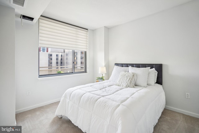 carpeted bedroom with visible vents and baseboards