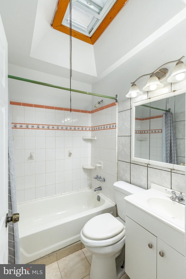 full bath featuring toilet, vanity, tile walls, tile patterned floors, and shower / bath combination with curtain