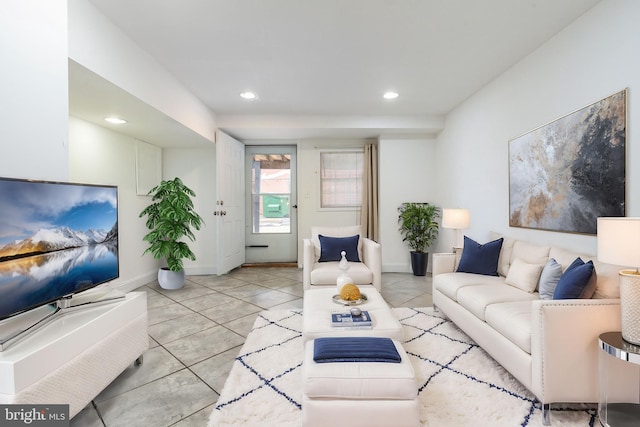 living room featuring light tile patterned floors, baseboards, and recessed lighting