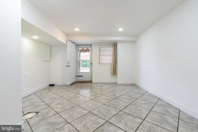 spare room with baseboards and recessed lighting