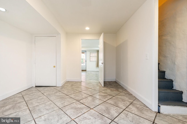 empty room featuring recessed lighting, stairway, baseboards, and light tile patterned floors