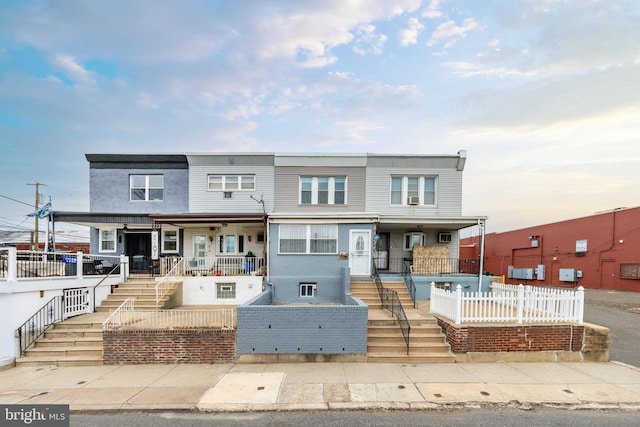 multi unit property featuring a porch and stairway