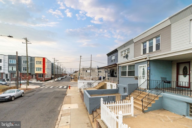 view of street with sidewalks, a residential view, and curbs