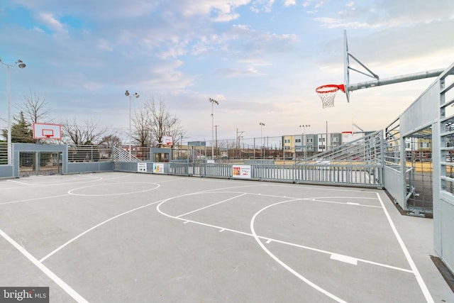 view of basketball court with community basketball court and fence