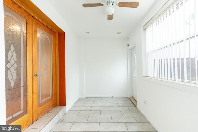 interior space featuring baseboards and light tile patterned floors