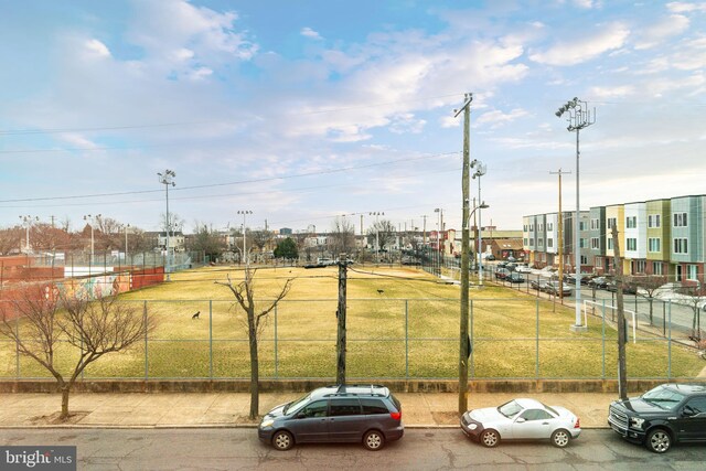 view of vehicle parking featuring fence