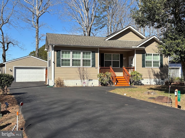 view of front of house with a shingled roof, an outbuilding, a garage, and crawl space