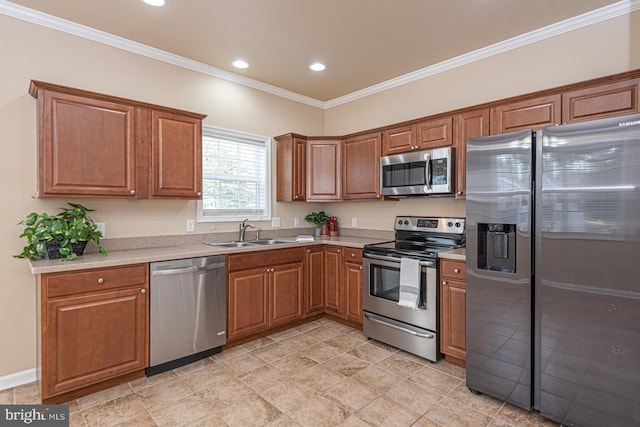 kitchen with a sink, brown cabinets, appliances with stainless steel finishes, and crown molding