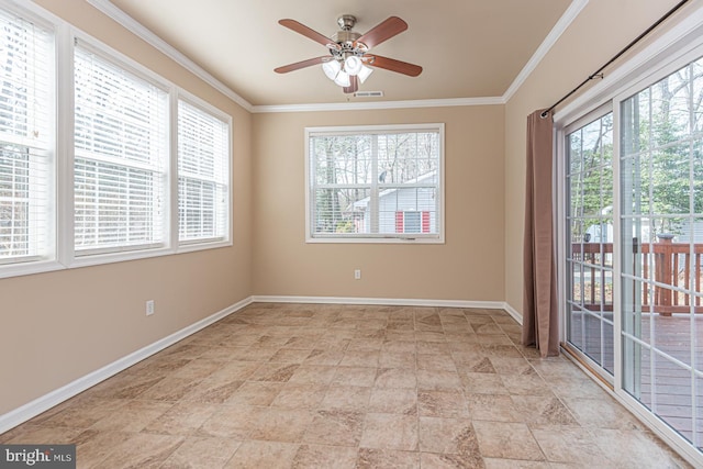 spare room featuring visible vents, baseboards, ornamental molding, and a ceiling fan