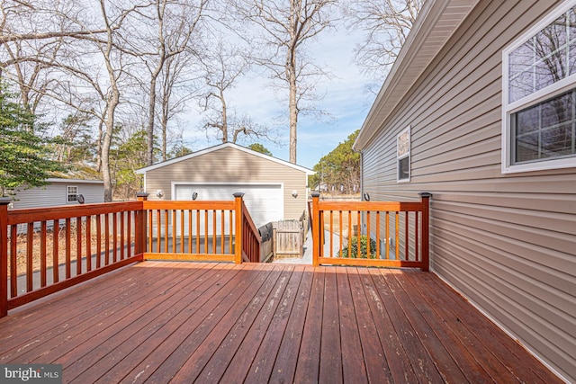 wooden deck with an outbuilding and a garage