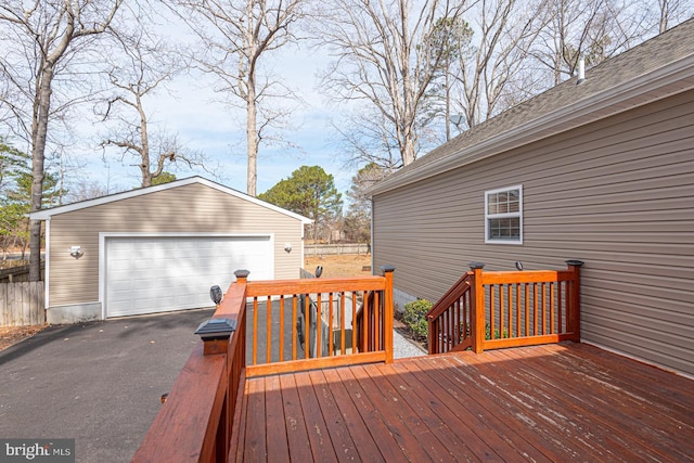 deck with an outdoor structure and a detached garage