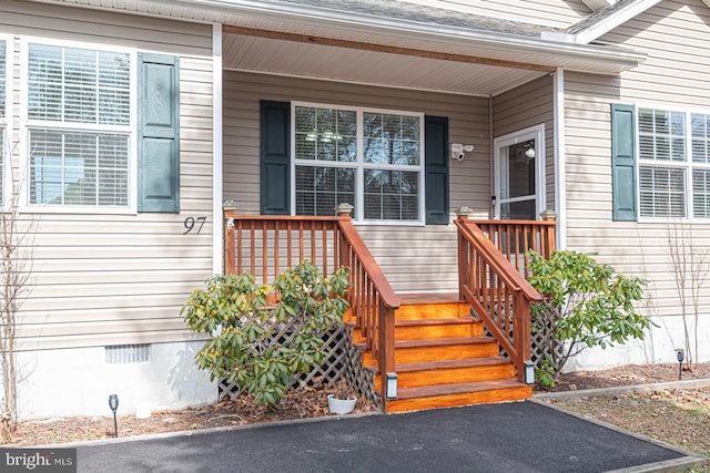 entrance to property with crawl space and a porch