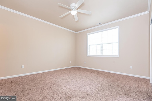 empty room featuring visible vents, crown molding, ceiling fan, baseboards, and carpet floors