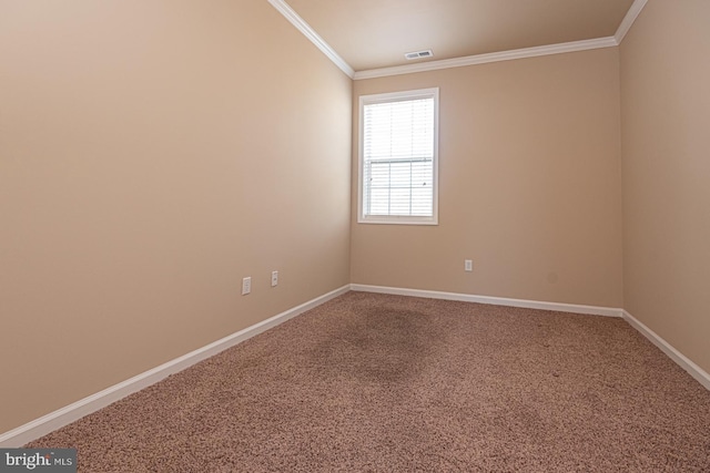 unfurnished room with visible vents, carpet, baseboards, and ornamental molding