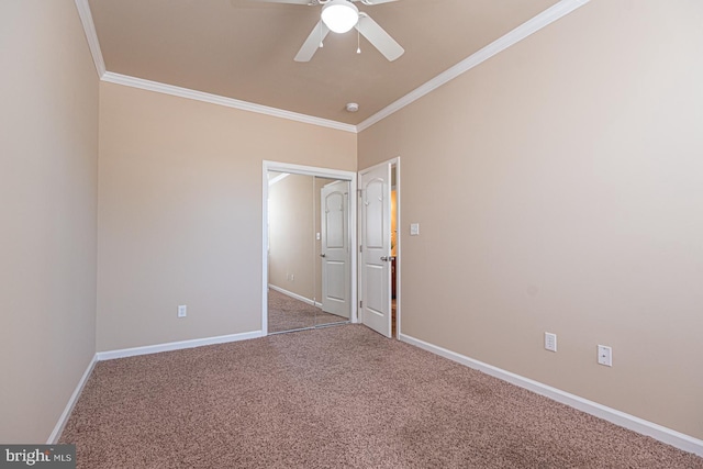 unfurnished bedroom featuring baseboards, a ceiling fan, carpet, and ornamental molding