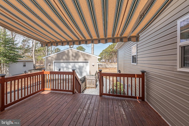 wooden terrace featuring an outdoor structure and fence