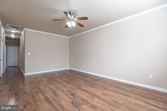 unfurnished room featuring ornamental molding, a ceiling fan, baseboards, attic access, and dark wood-style flooring