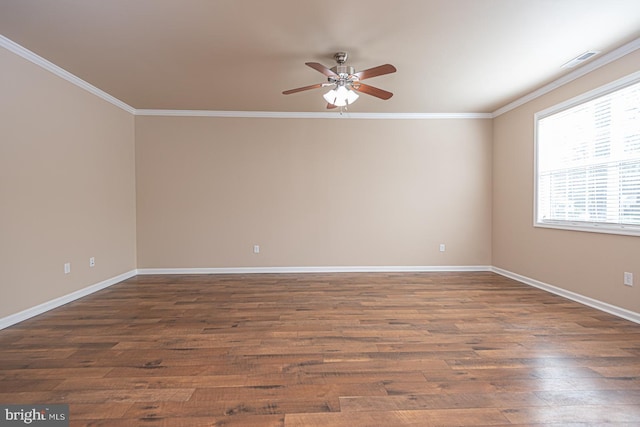 unfurnished room featuring visible vents, baseboards, ornamental molding, and dark wood-style flooring