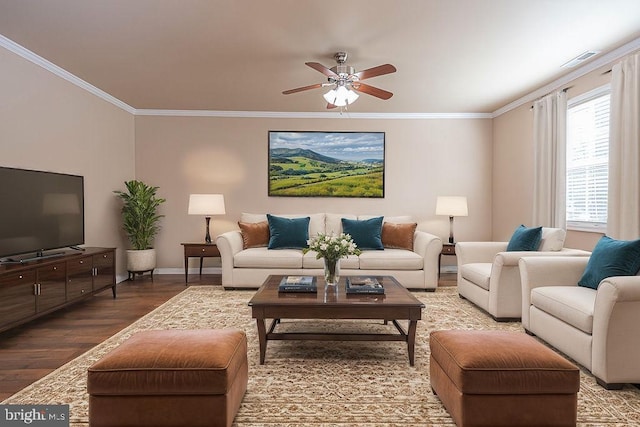 living room with a ceiling fan, crown molding, wood finished floors, and visible vents