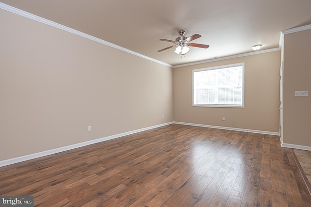 spare room with ceiling fan, baseboards, dark wood finished floors, and crown molding