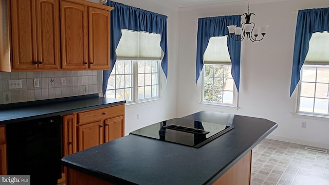 kitchen featuring plenty of natural light, visible vents, dark countertops, black appliances, and backsplash