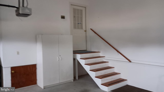 stairway with concrete flooring