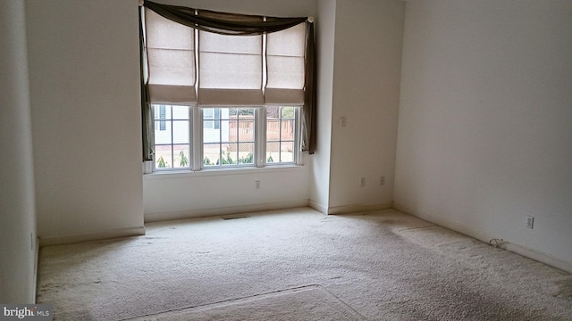 carpeted spare room with visible vents