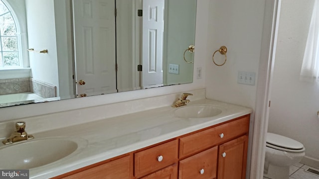 full bath with tile patterned flooring, a sink, toilet, and double vanity