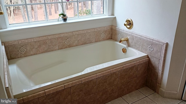 bathroom featuring tile patterned flooring and a bath