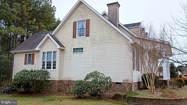 view of home's exterior featuring crawl space and a chimney