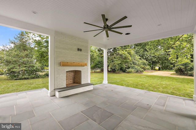 view of patio / terrace with a ceiling fan and an outdoor brick fireplace