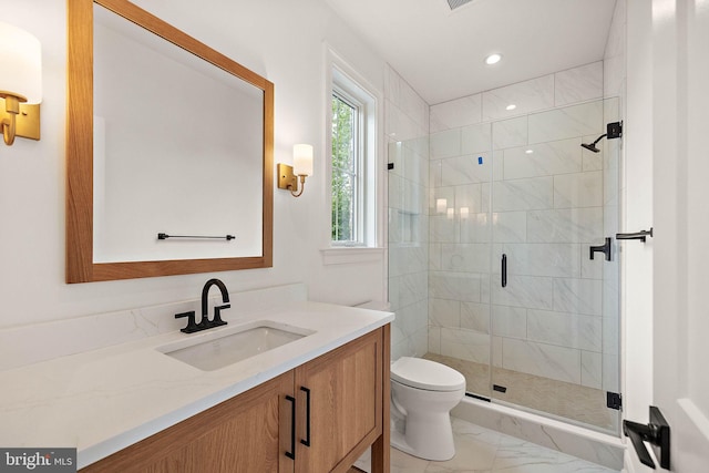 bathroom featuring toilet, marble finish floor, a stall shower, recessed lighting, and vanity