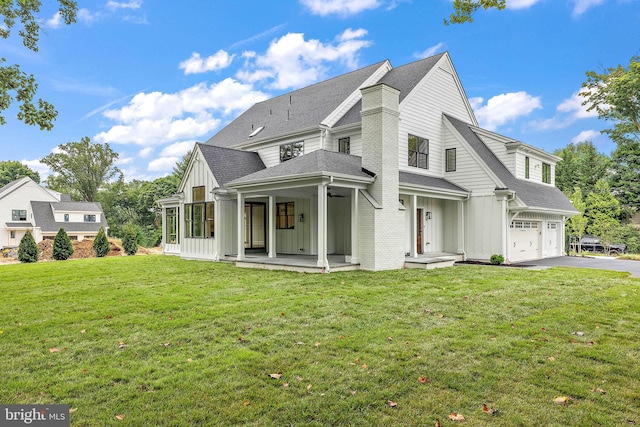 view of front of property with driveway, a shingled roof, board and batten siding, an attached garage, and a front yard