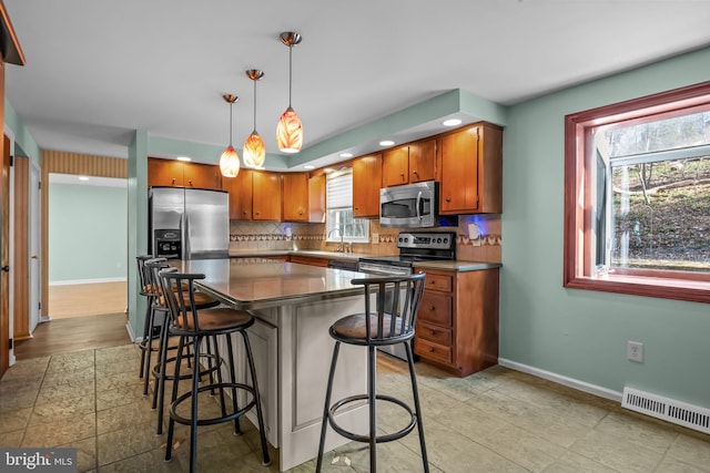 kitchen with baseboards, visible vents, decorative backsplash, appliances with stainless steel finishes, and a sink