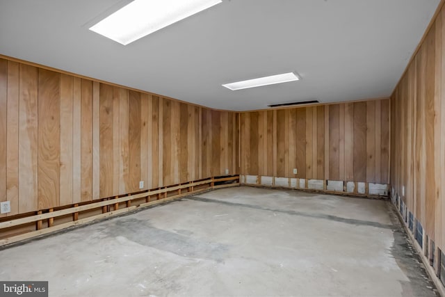 interior space featuring concrete flooring and wood walls