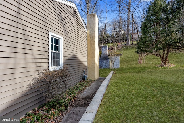 view of home's exterior with a lawn