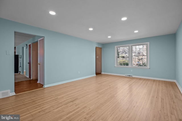 empty room with recessed lighting, visible vents, and light wood-style floors