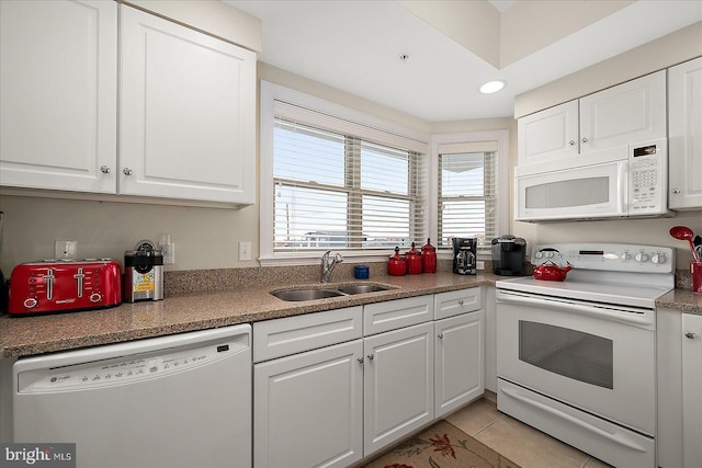 kitchen featuring light tile patterned floors, recessed lighting, white cabinets, a sink, and white appliances