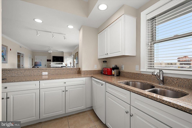 kitchen featuring light tile patterned floors, ceiling fan, white dishwasher, white cabinetry, and a sink