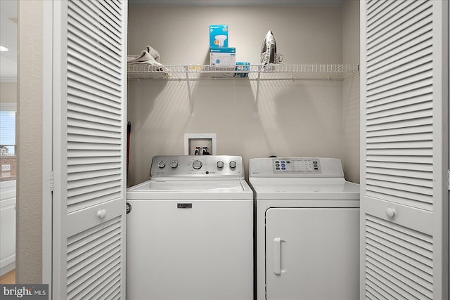 washroom featuring laundry area and separate washer and dryer