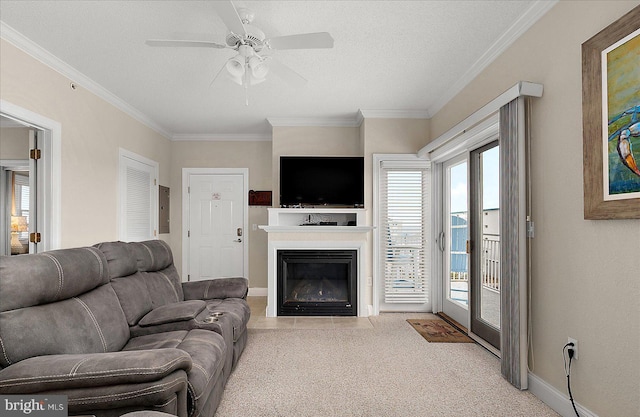 carpeted living room featuring ornamental molding, a glass covered fireplace, a textured ceiling, and baseboards