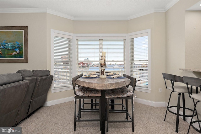 dining space with light colored carpet, crown molding, and baseboards