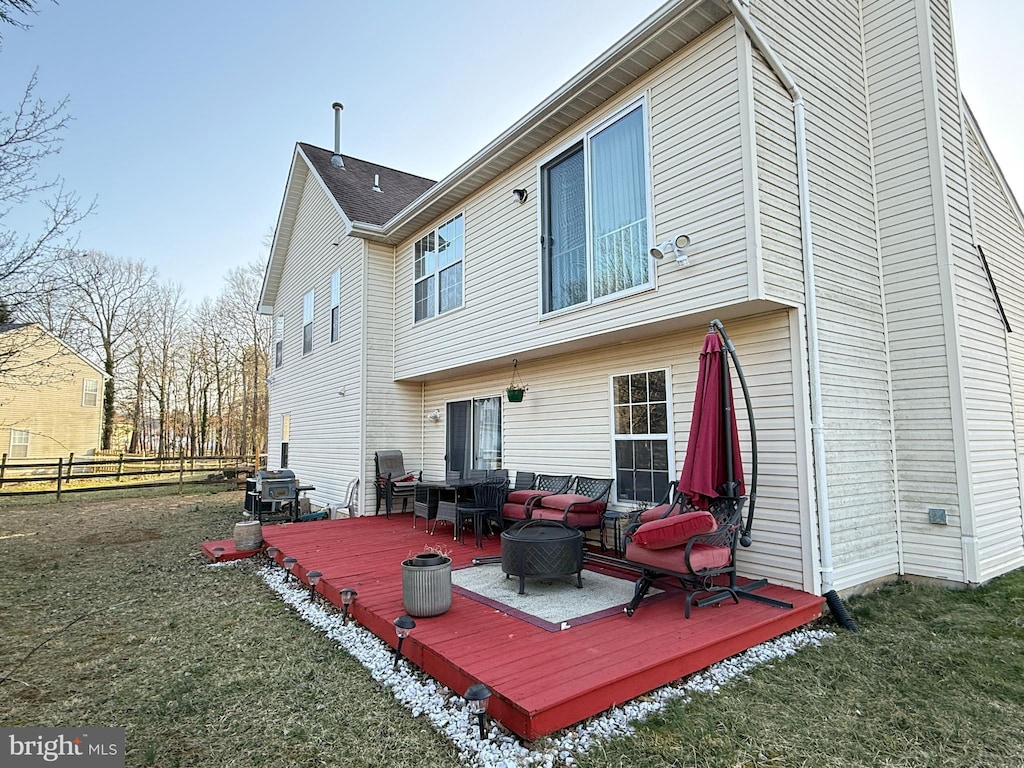 back of house featuring a wooden deck, an outdoor hangout area, and fence