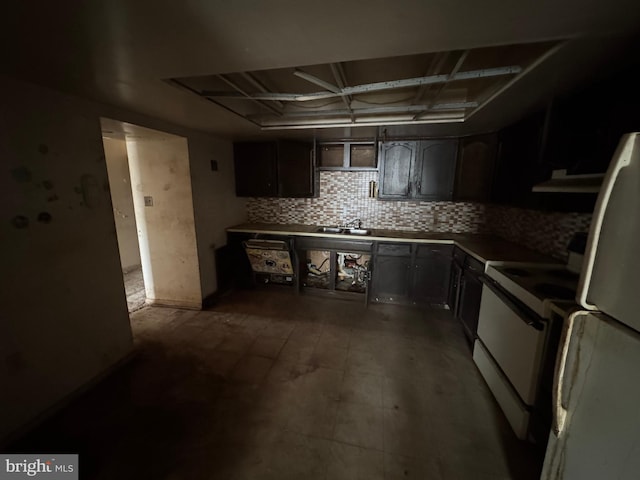 kitchen with white appliances, tasteful backsplash, and a sink